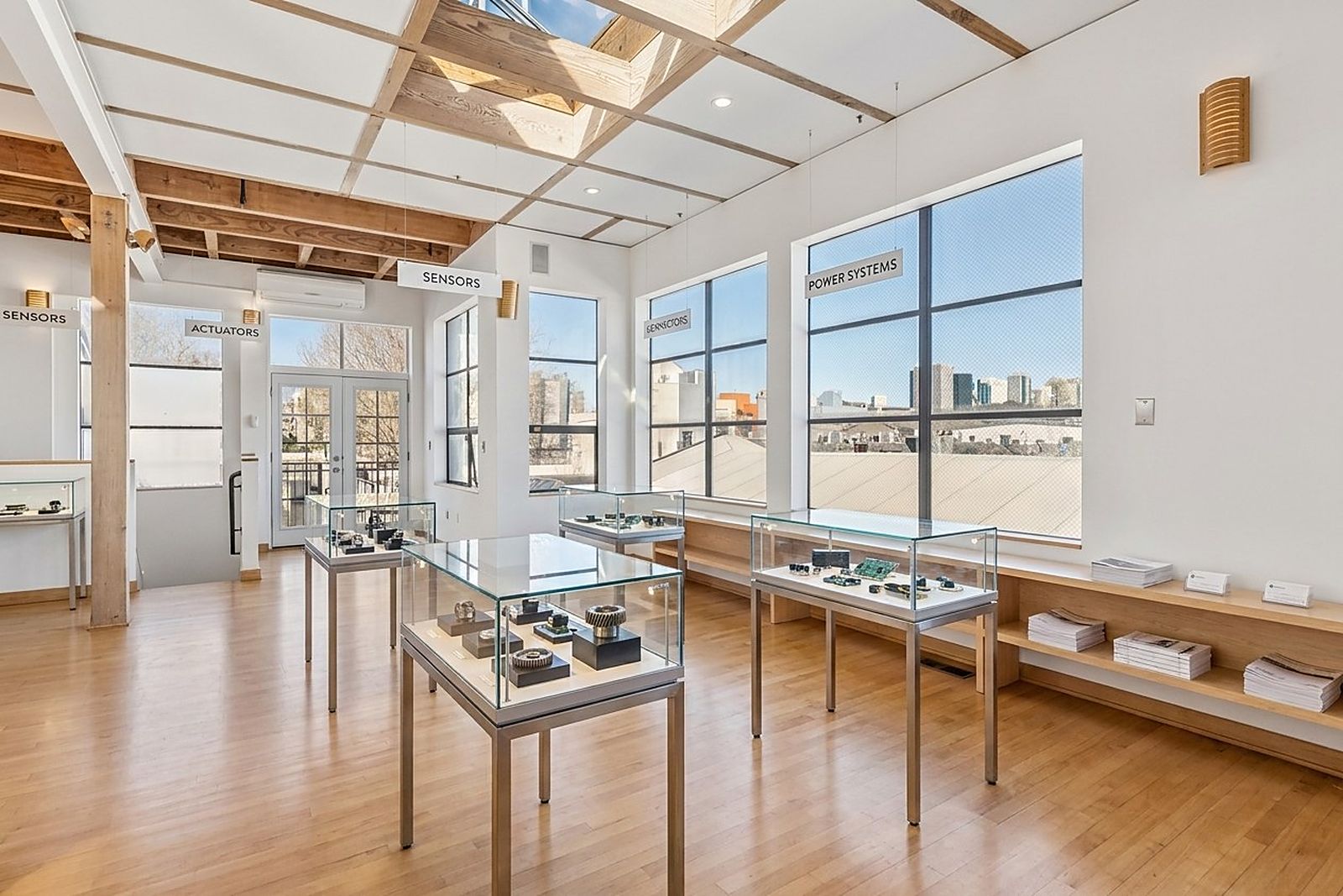 Display cases in a quiet room with a city view