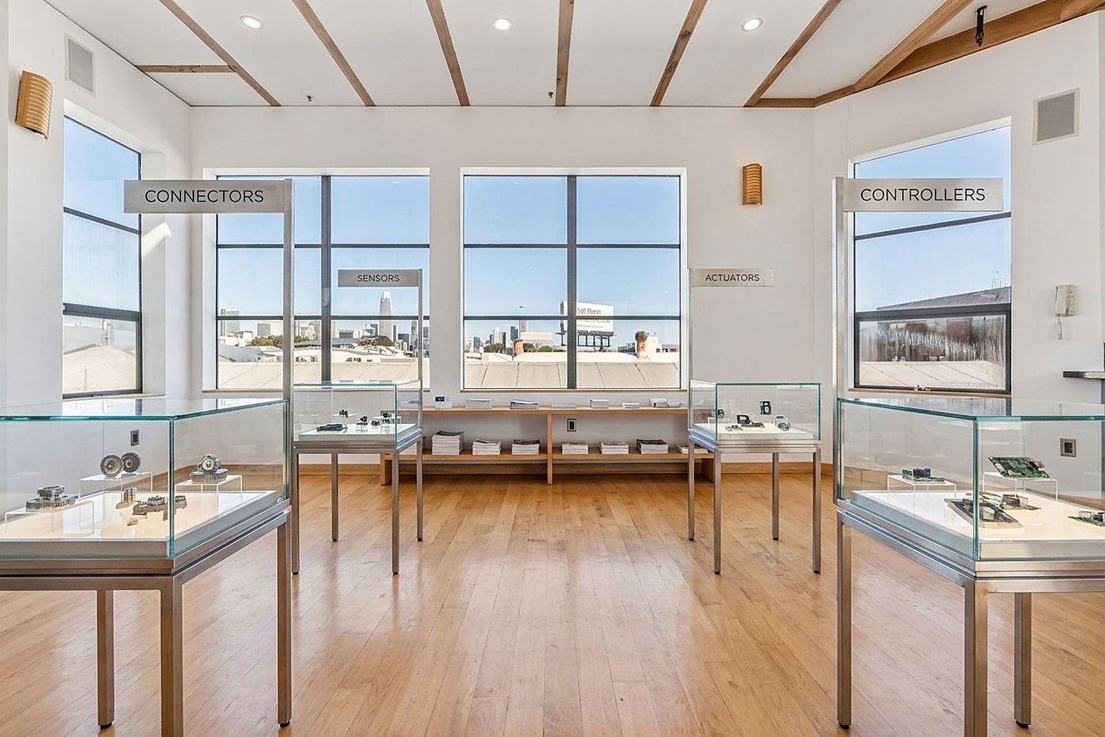 Display cases in a quiet loft room with a city view
