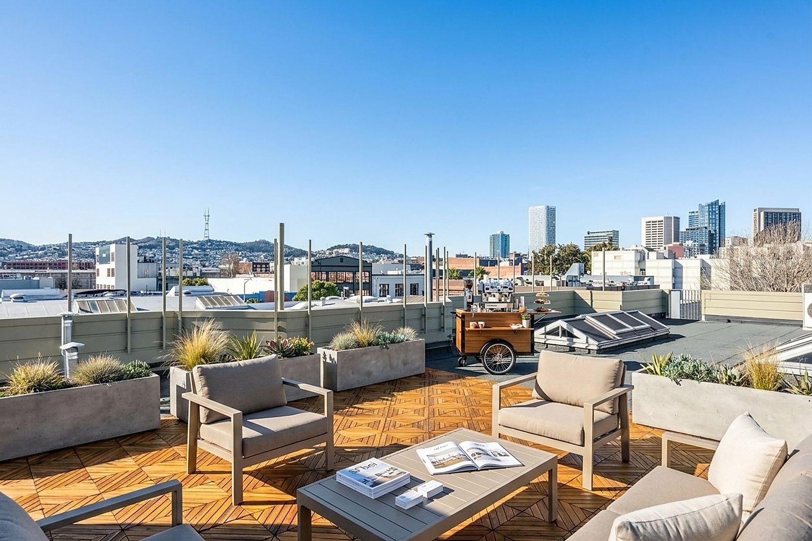 Lounge seating on the roof terrace with a city view