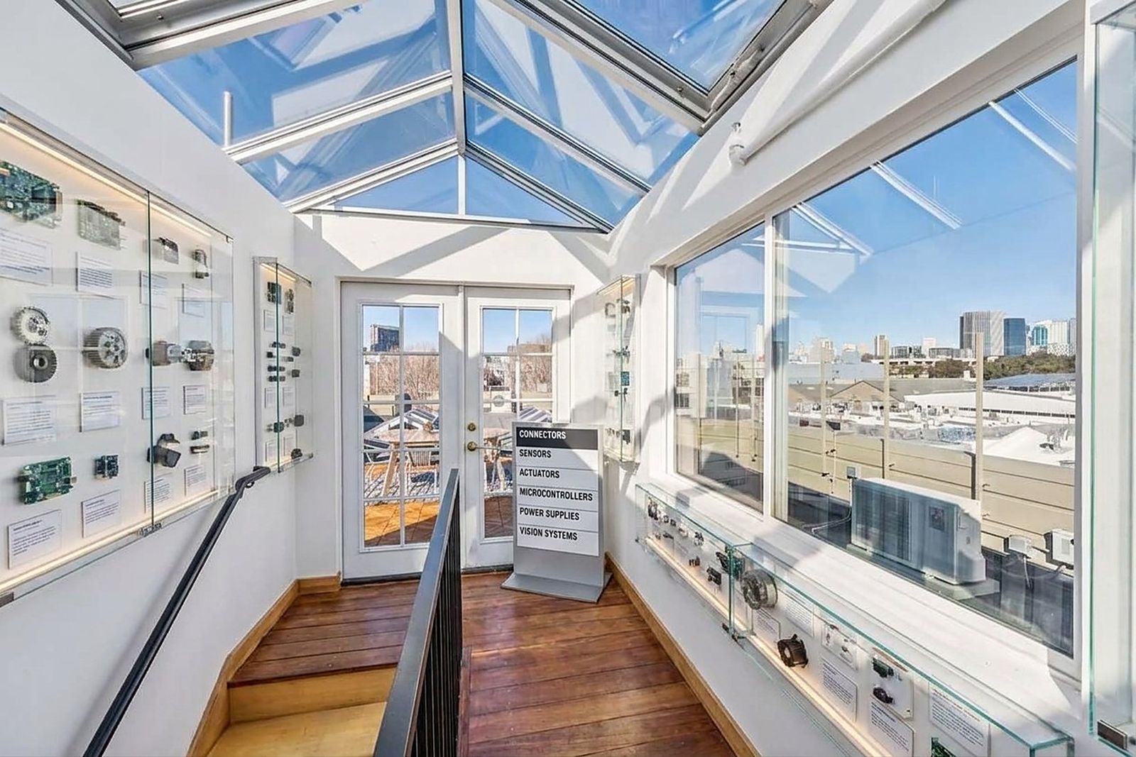 Display cases lining the skylit stair gallery